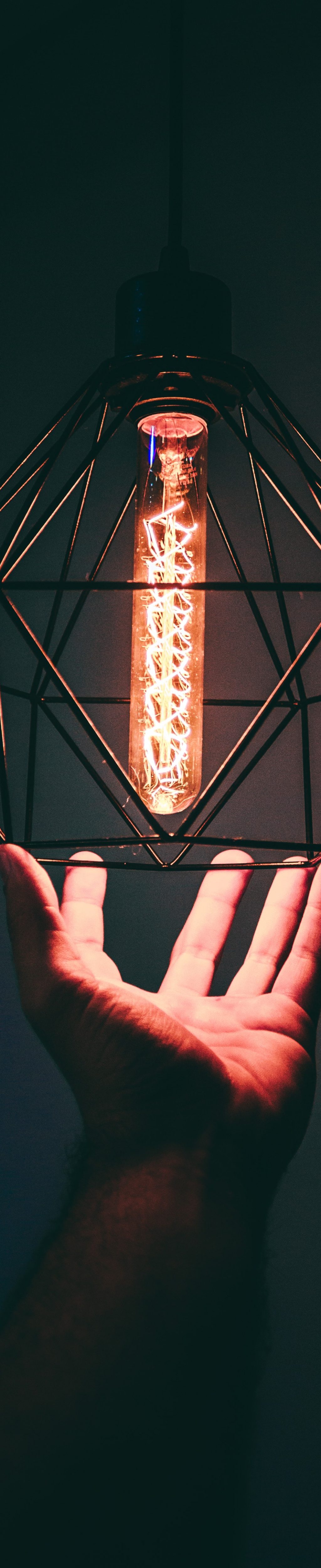 person-holding-pendant-light-973506